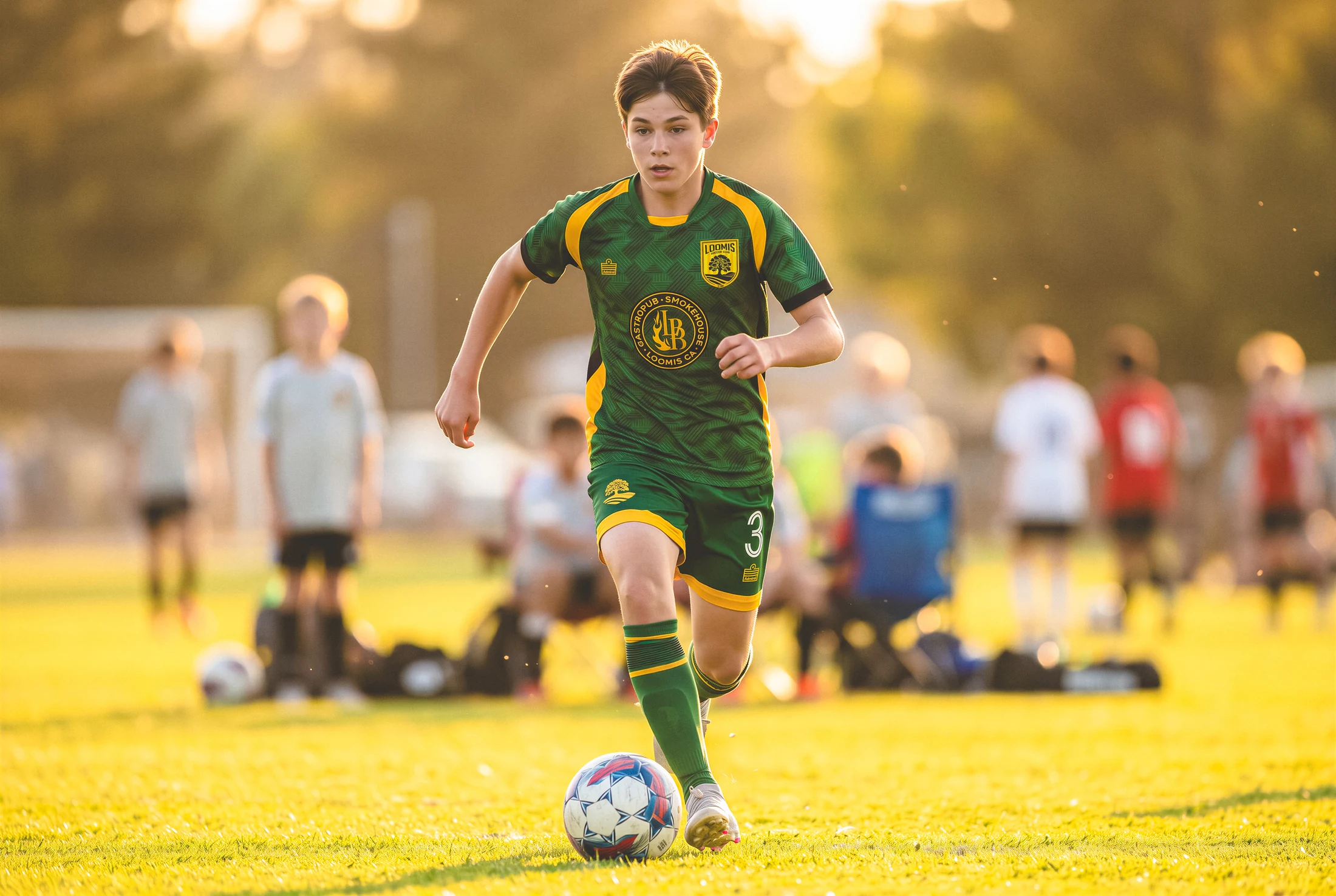 Loomis player dribbling in the forest-green alternate kit