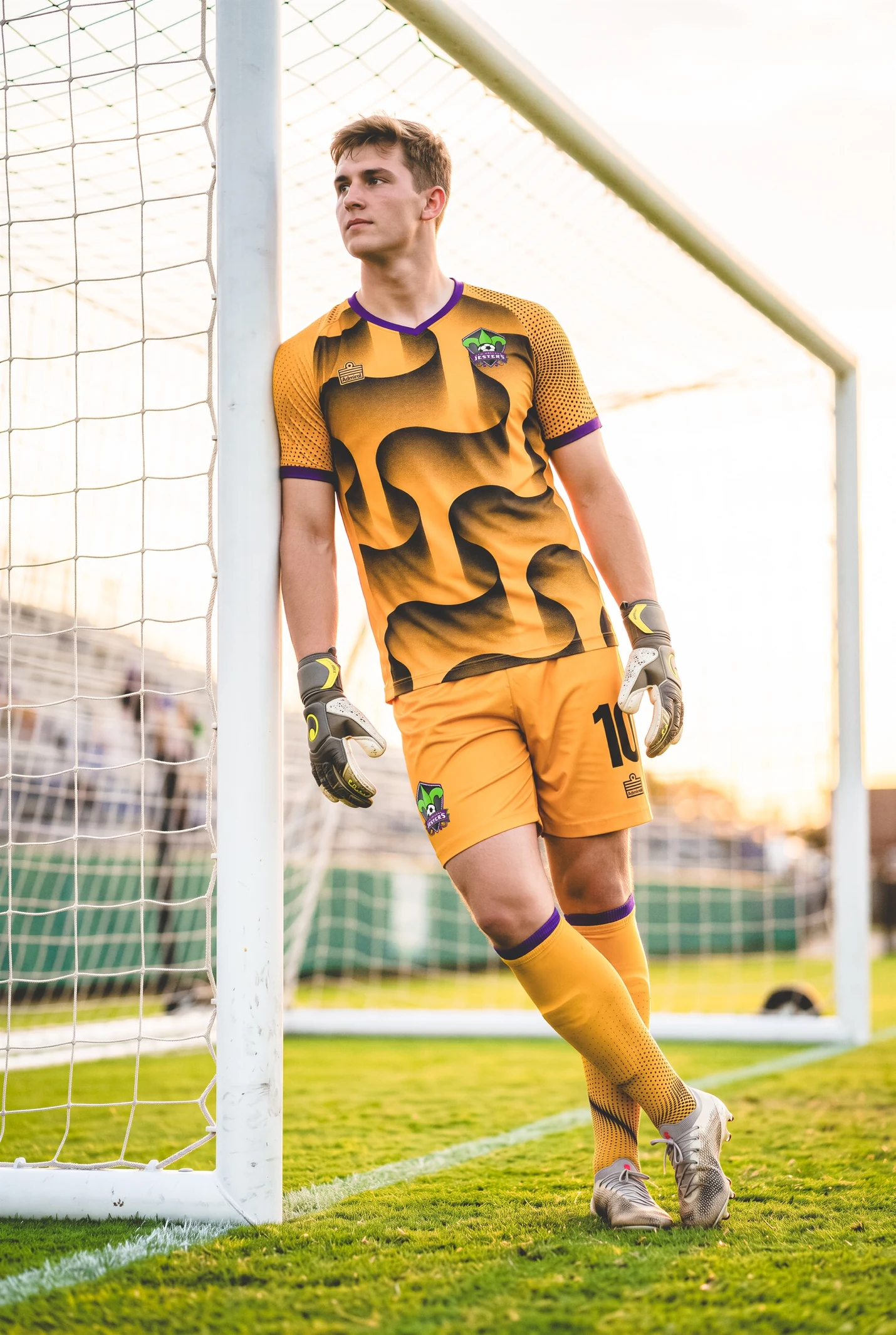 A goalkeeper wearing the gold and black river-inspired Jesters kit