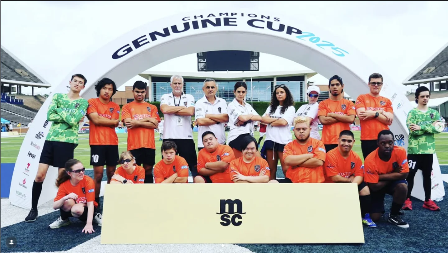 Athletes and supporters under the Genuine Cup arch